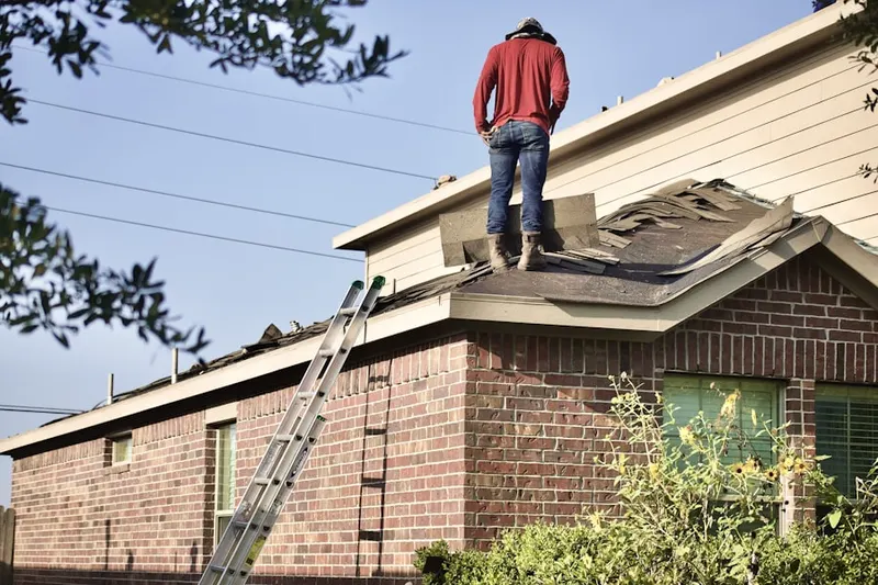 Professional roofer working on a residential roof in Hendrick Estates